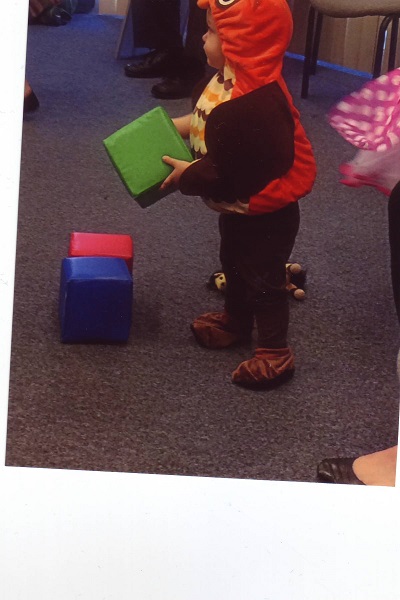 a child playing with one of the square blocks at Make it Take it